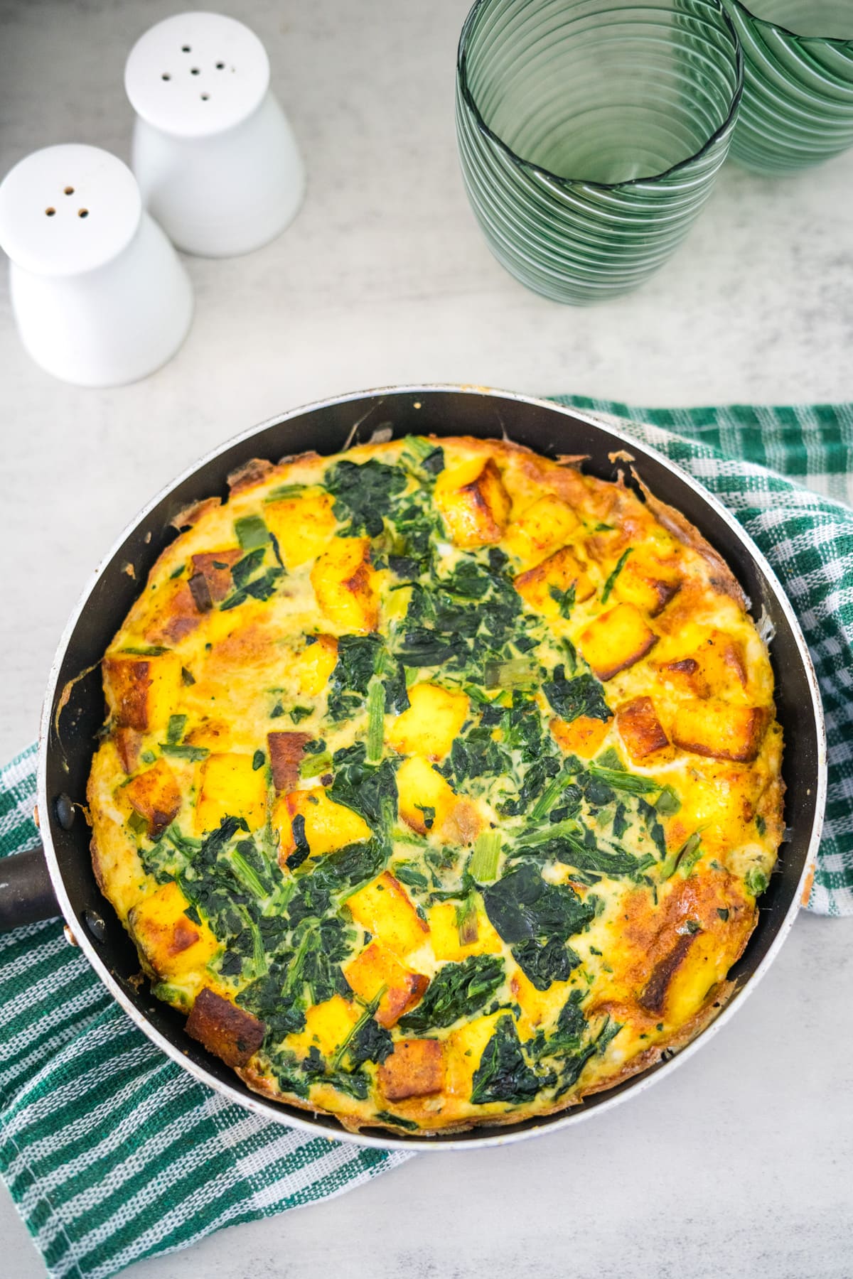 A skillet spinach and cheese quiche.
